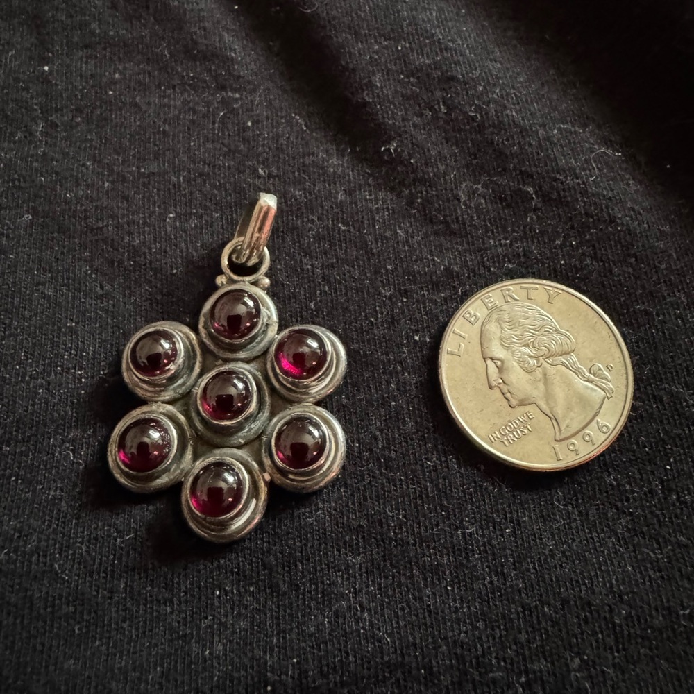 pendant with 7 garnet colored gemstones.